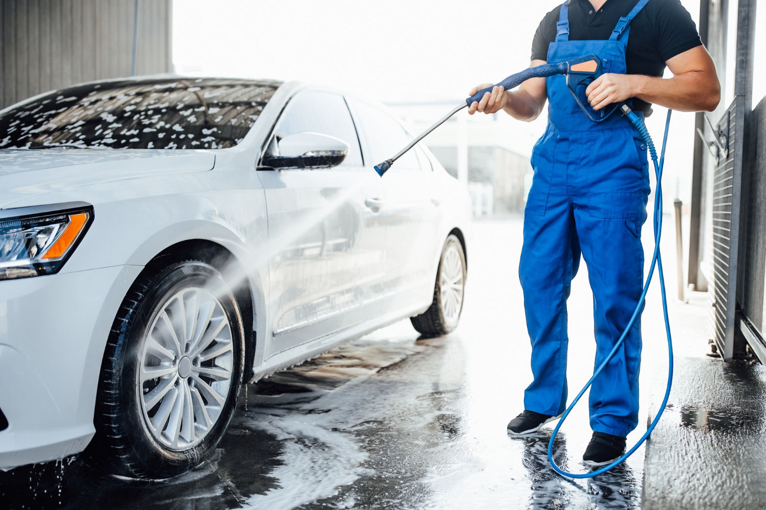Professional washing a white car at Ozone Wagonz Car Care, Belur Road Chikkamagaluru